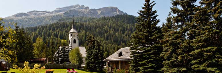Corvara, in Alta Badia, among green forest