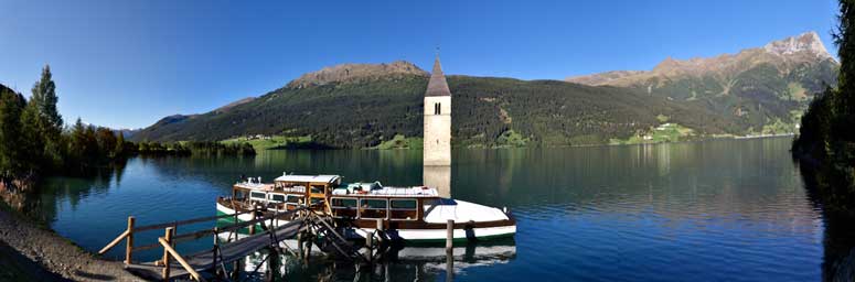 The fascinating Resia lake with the bell tower of Curon