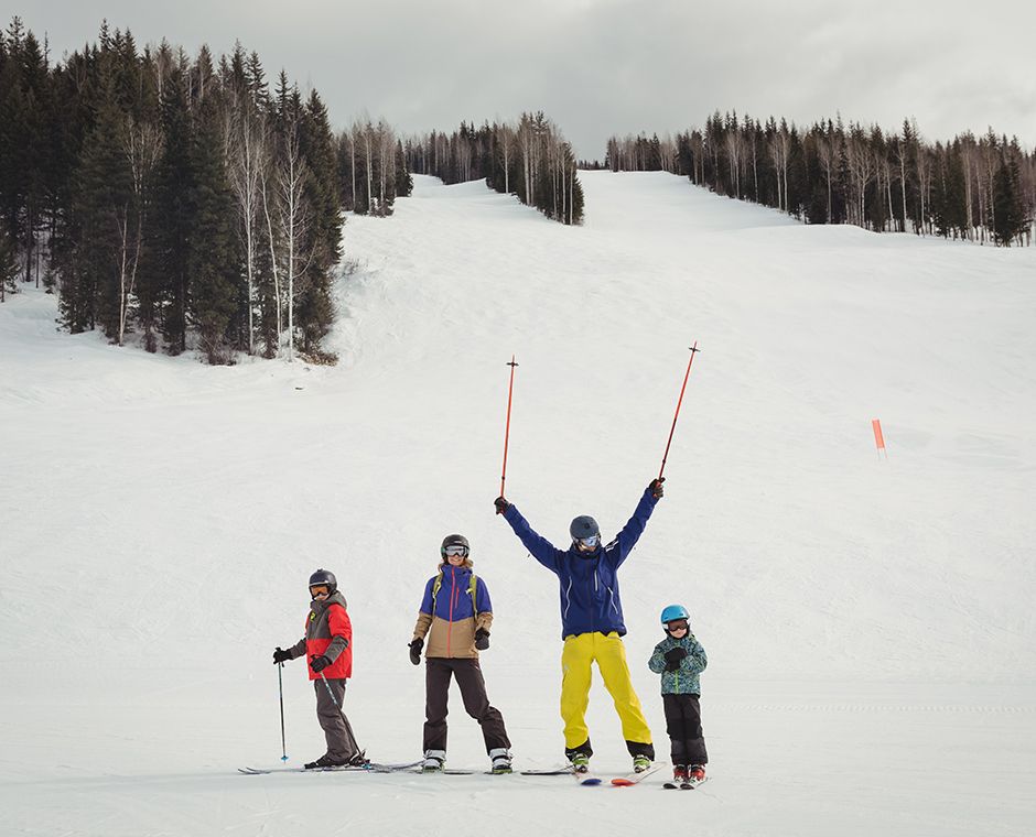 Family having fun skiing in winter