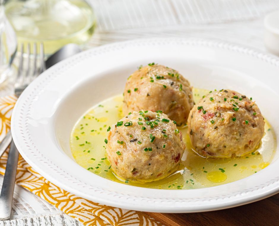 A bowl of speck dumpling soup