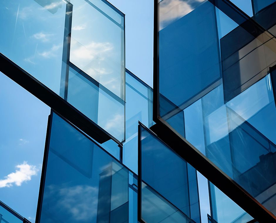 Modern glass facade with reflections of the sky