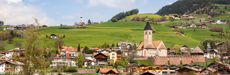 View of Siusi allo Sciliar, among meadows and forests